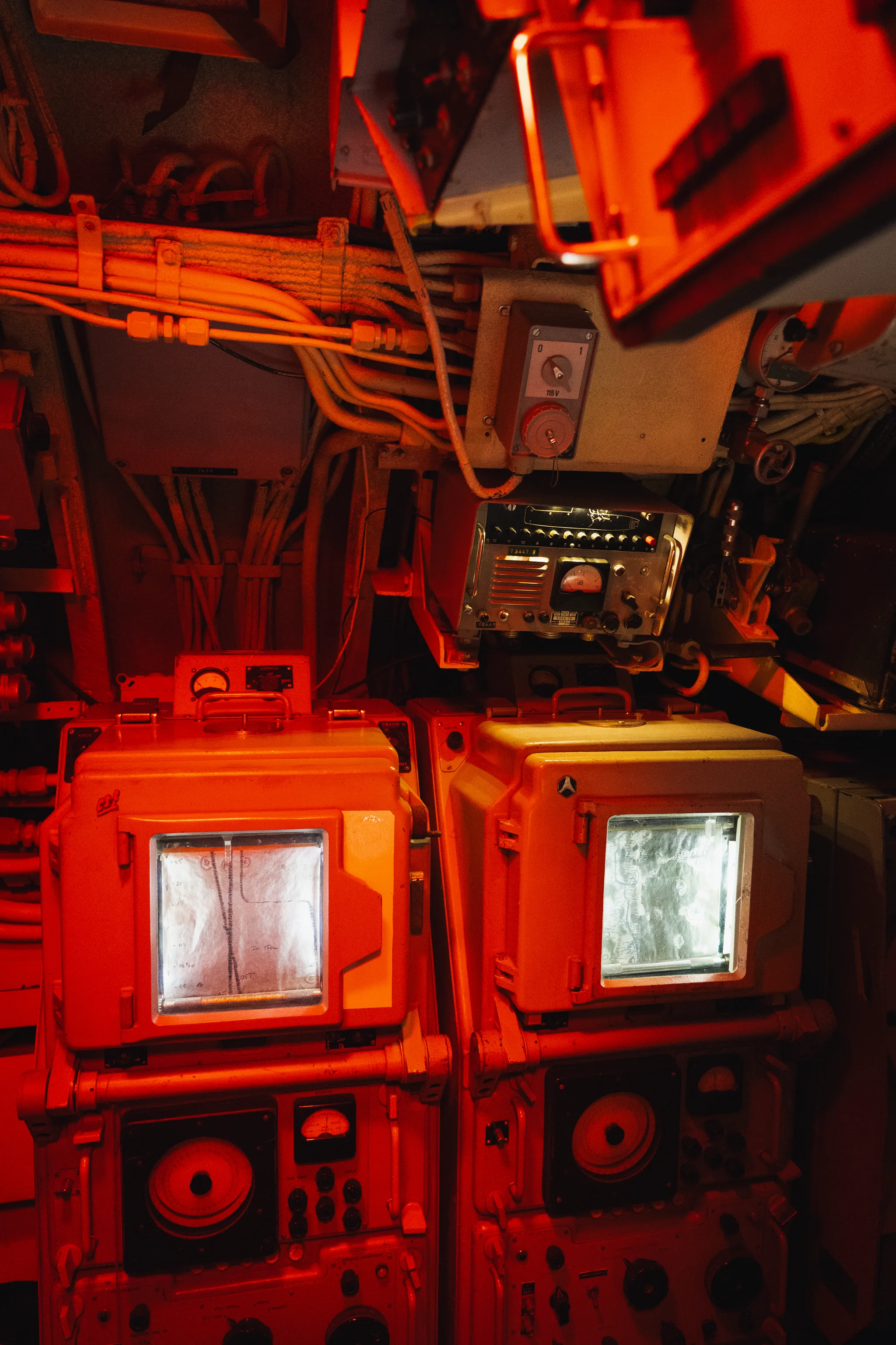 Red-lit control panels and screens inside the submarine Flore